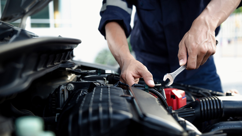 A mechanic works on a car.