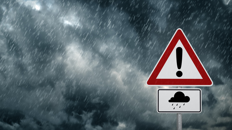 Stormy skies are shown with a warning sign.