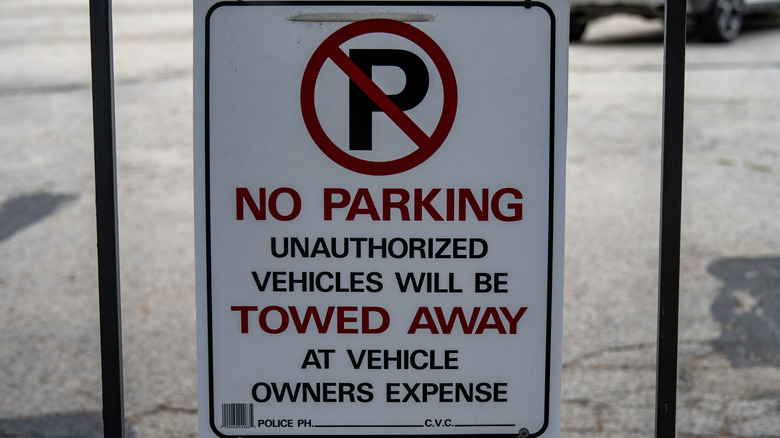 A no parking sign is shot up close.