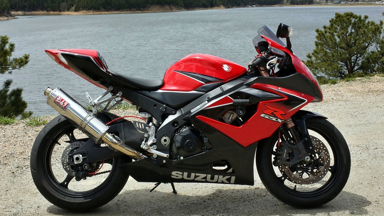 A red Suzuki GSX-R1000 shot from the right side near a body of water.