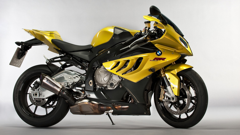 A yellow 2010 BMW S 1000 RR seen from its right side in a studio.