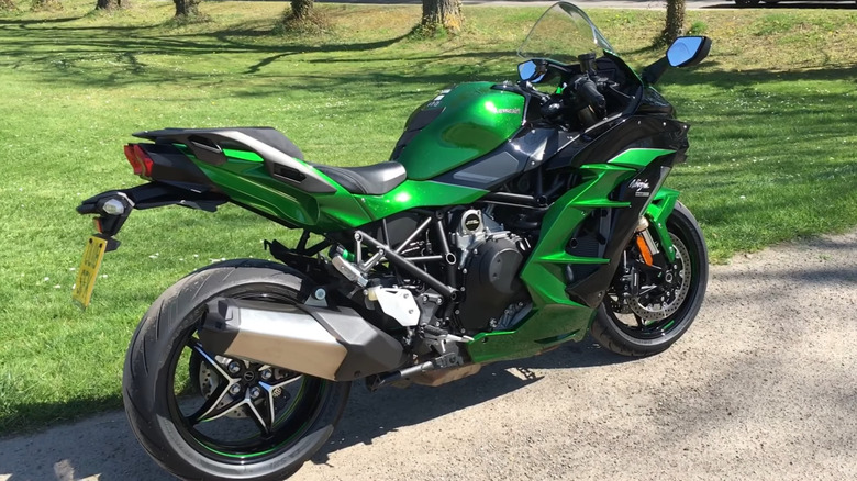 A green 2018 Kawasaki Ninja H2 SX SE sits parked.