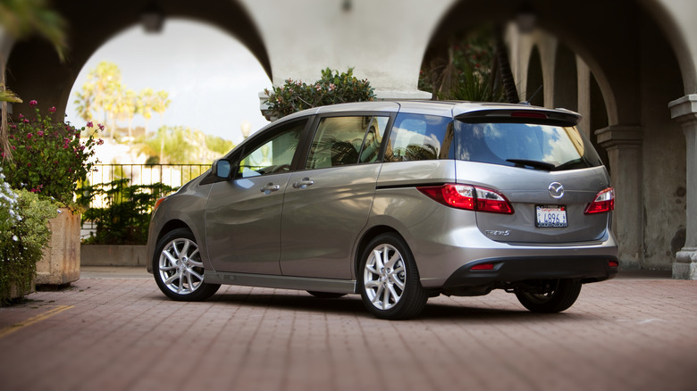 A Mazda5 sits parked under archways.