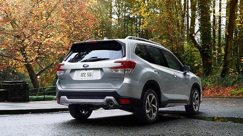A Subaru Forester sits parked in the woods.