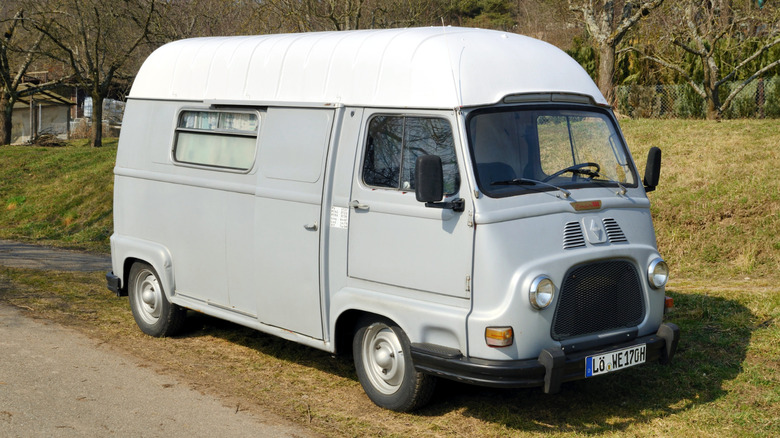 A Renault Estafette parked on grass next to a road.
