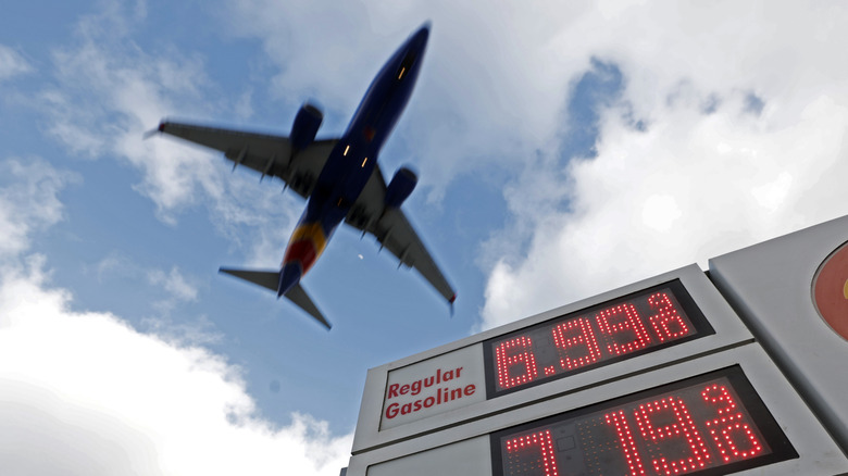 Gas prices are displayed at a Shell gas station as an airplane approaches San Diego International Airport for a landing on April 24, 2026 in San Diego, California.