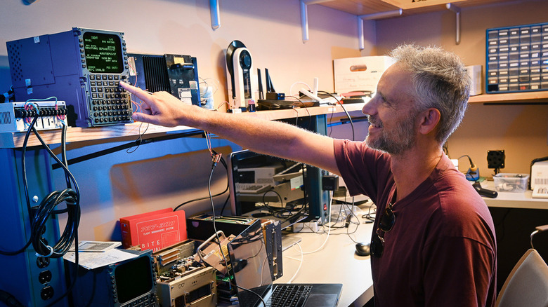 Aaron Schulman, a faculty member in the UC San Diego Department of Computer Science and Engineering, interacts with one of the computers researchers were able to take over.