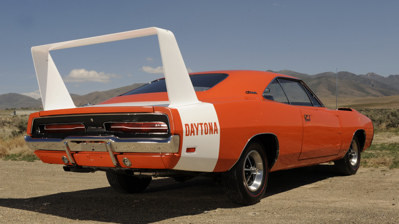 An orage 1969 Dodge Daytona with large spoiler