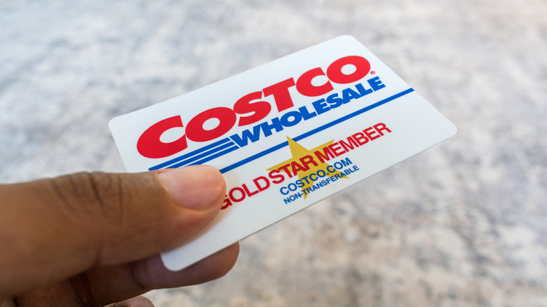 A member holding a Costco Gold Star Member card