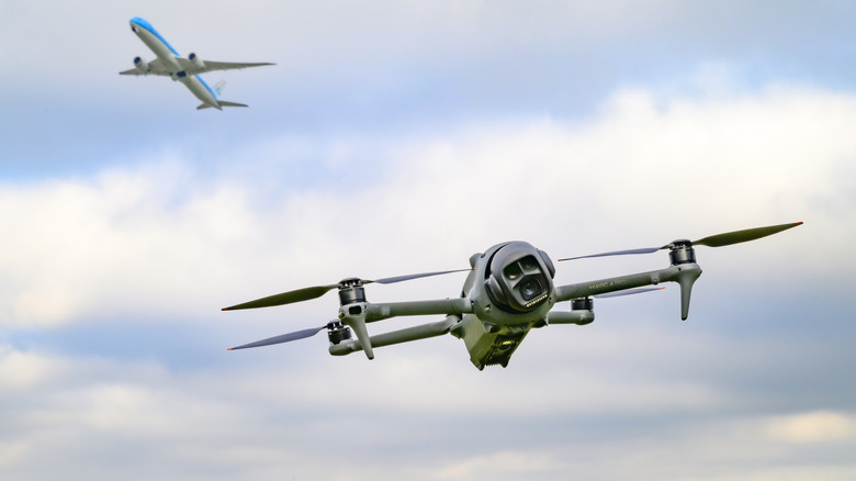 A drone flies near Schiphol Airport in the Netherlands as a plane takes off