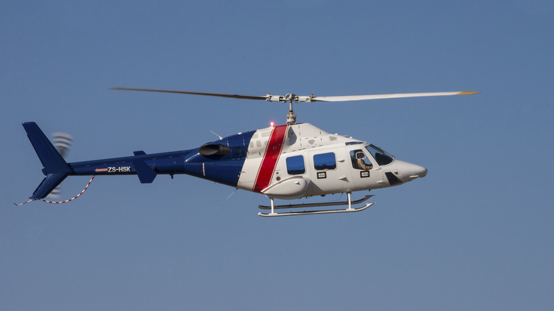 A Bell 222 helicopter flies past at the Rand Airshow at Rand Airport