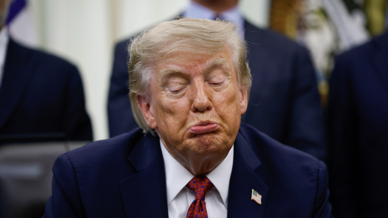 Donald Trump looks downward
