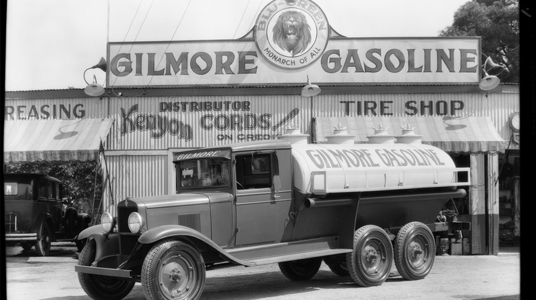 A Gilmore Gasoline station with an image of a lion and the words "Monarch of All" atop the company's name.