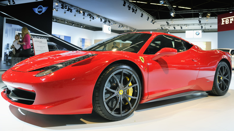 A red Ferrari 458 Italia parked at a car show.