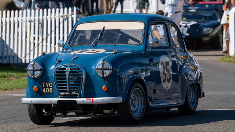 A classic Austin A35 converted race car competing at a vintage car racing event.