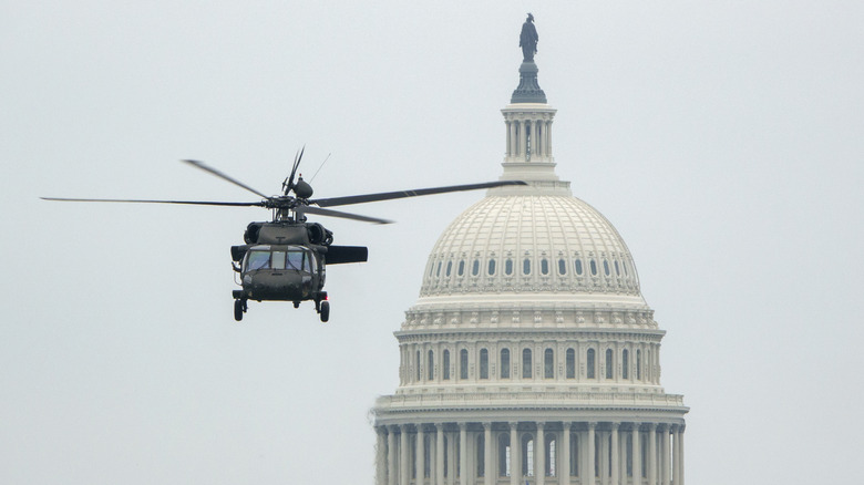 A Black Hawk helicopter flies in front of the Capitol Building