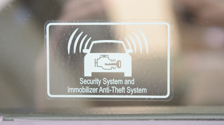 "Security system and immobilizer anti-theft system" sticker on a car window
