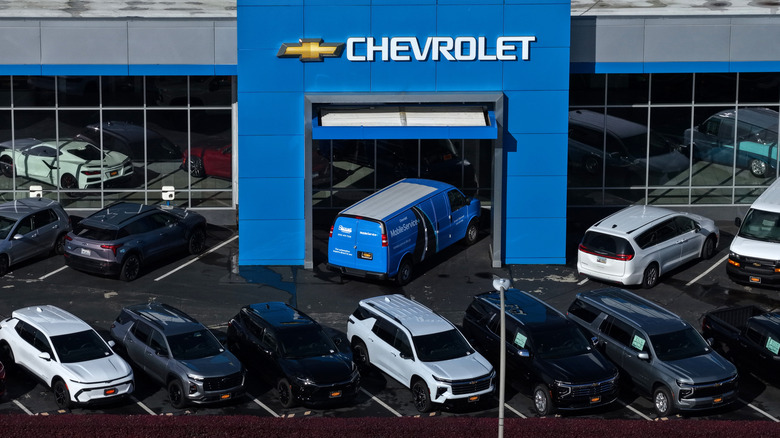 An overhead view of a chevrolet dealership with large chevy SUVs parked outside