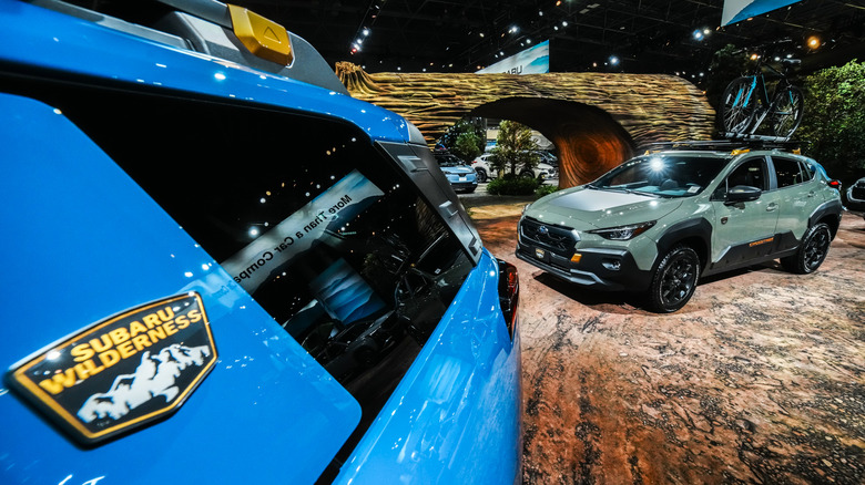 Subarus on the floor of the New York Auto Show on a set that is supposed to look like the great outdoors