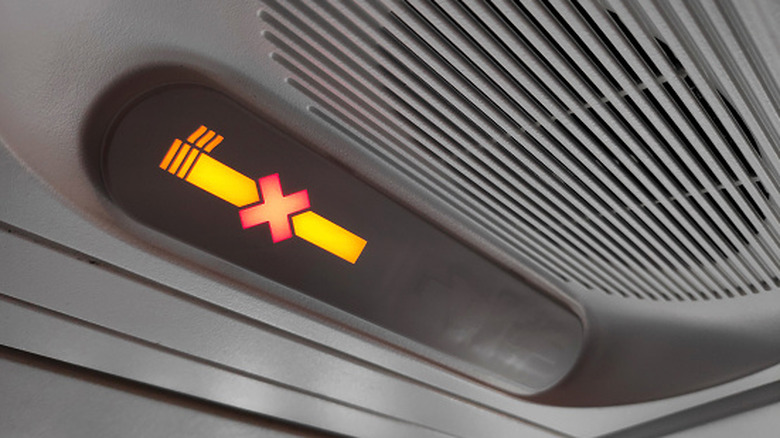 No smoking sign on plane illuminated