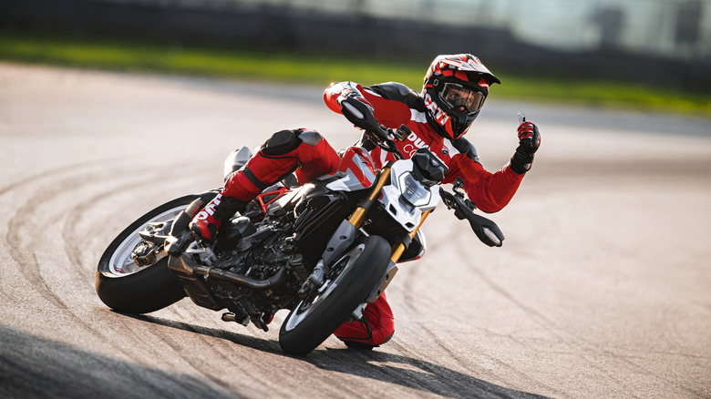 A rider drifts a Ducati Hypermotard supermoto