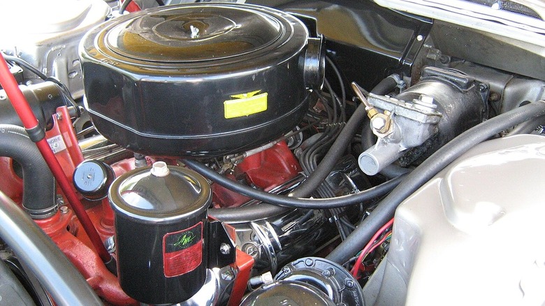 A 1957 Rambler Rebel's carbureted V8 engine under its hood