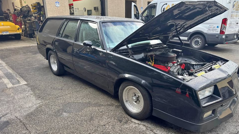 Black Chevy Malibu wagon with its hood open