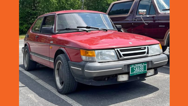 A red Saab 900 Turbo hatchback