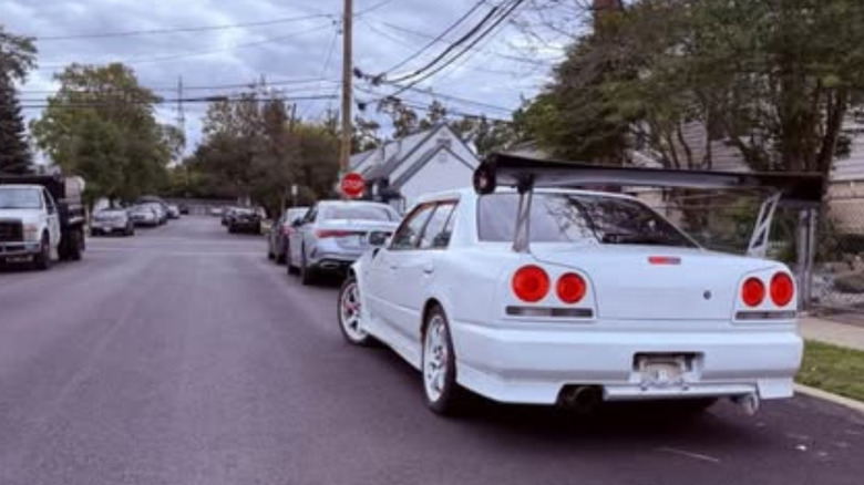 White four-door Nissan Skyline