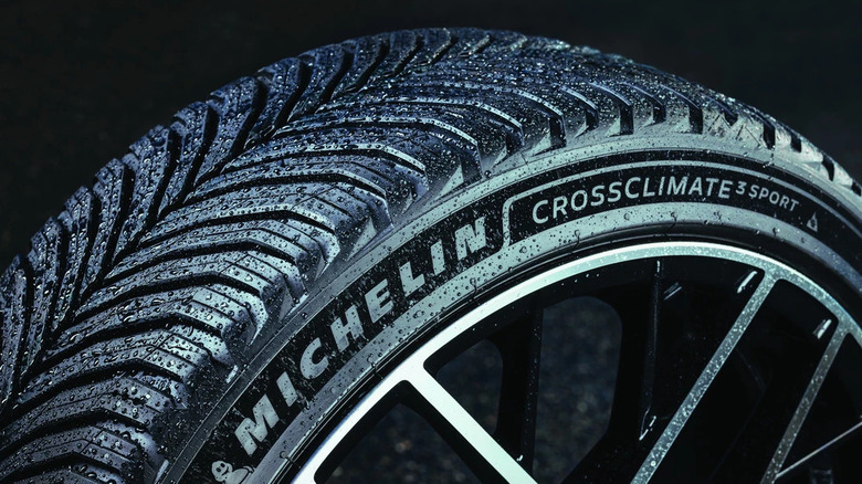 A close-up view of the new Michelin CrossClimate3 Sport tire against a dark backdrop