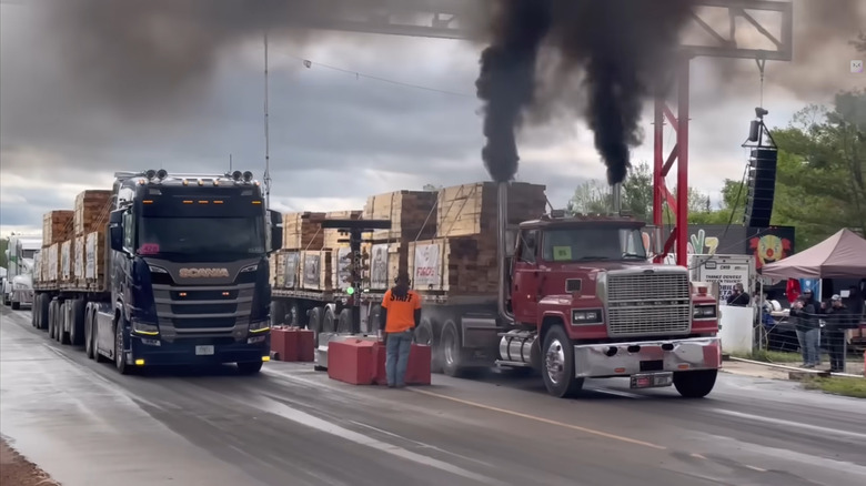 A European and an American semi-truck competing in a Semi drag race.