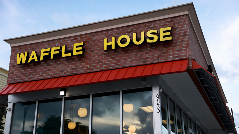 The front of a Waffle House under a blue sky
