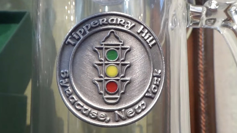 The upside-down traffic light of the Tipperary Hill neighborhood in Syracuse, New York, is immortalized on the side of a glass mug.