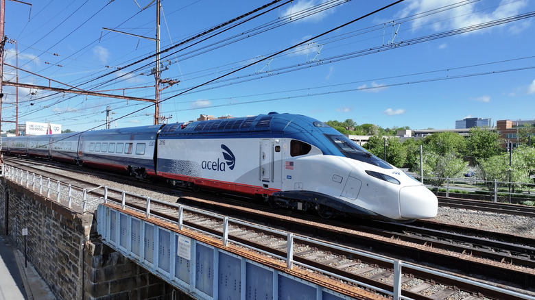 Amtrak's new NextGen Acela train crossing a rail bridge.