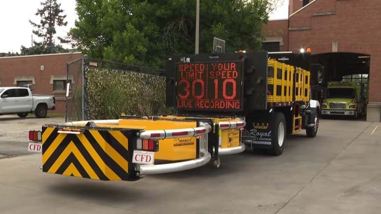 Cleveland's own barrier truck with speed limit sign and monitor activated in front of one of its fire stations