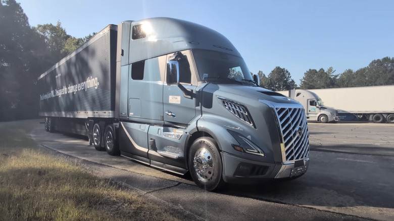 a blue Volvo VNL Semi truck parked at the Michelin Laurens Proving Grounds on a sunny day