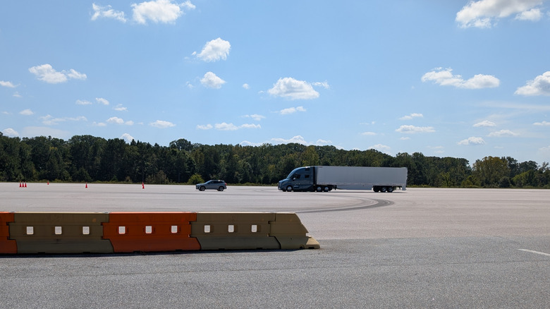 a blue Volvo VNL Semi truck stopping after being cut off at the Michelin Laurens Proving Grounds on a sunny day