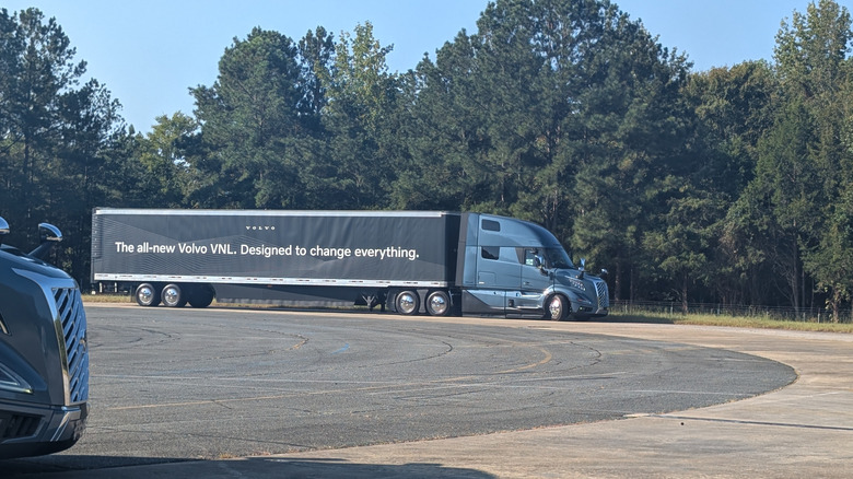 a blue Volvo VNL Semi truck parked at the Michelin Laurens Proving Grounds on a sunny day