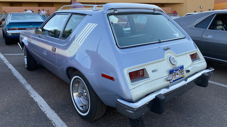A blue/white AMC Gremlin in a parking lot
