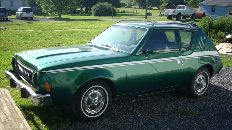 A dark green AMC Gremlin with white highlight strip and roof rack