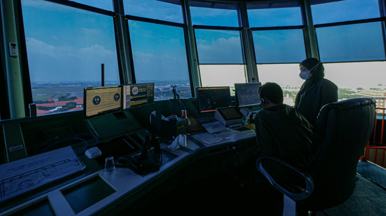 Air traffic controllers at work inside a tower