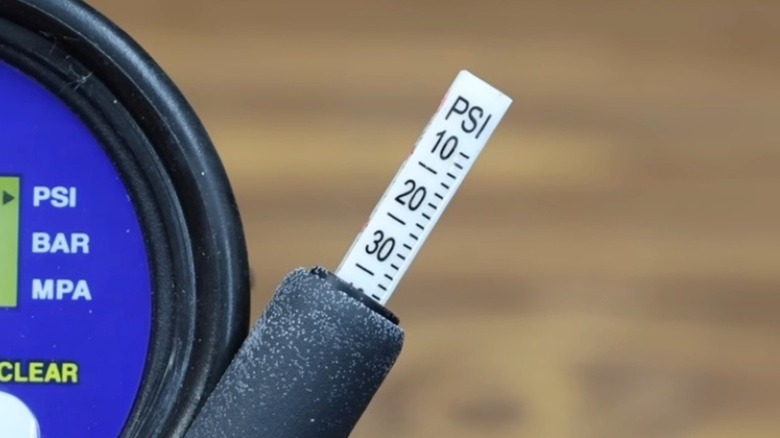 A closeup of PSI measurements on a tire pressure gauge