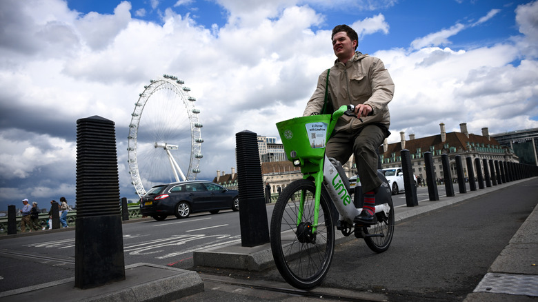 A commuter on a Lime rental bike pedals in London.