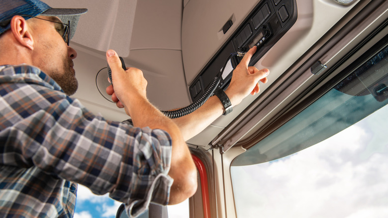 Professional Truck Driver Using CB Radio To Communicate with Others in a Convoy