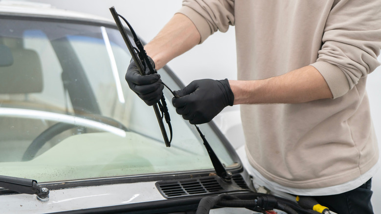 Man replacing the wiper blade of his car
