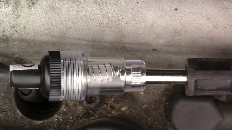 A close-up of an inline spark plug tester
