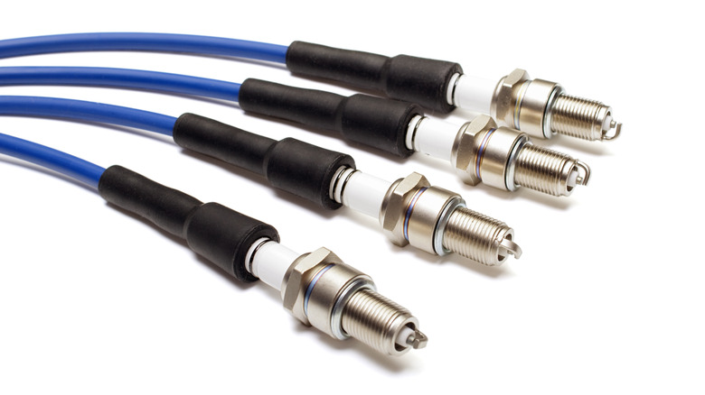 Four spark plug wires connected to four spark plugs