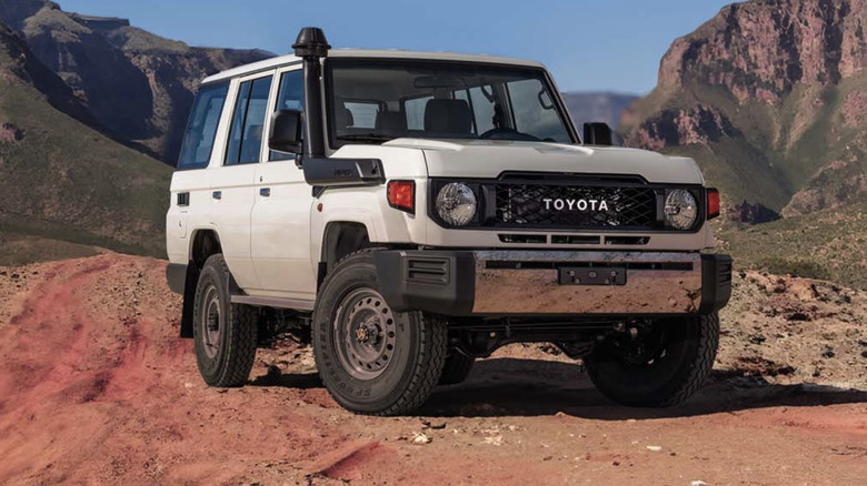 A Toyota Land Cruiser 76 Hardtop parked in a desert setting.