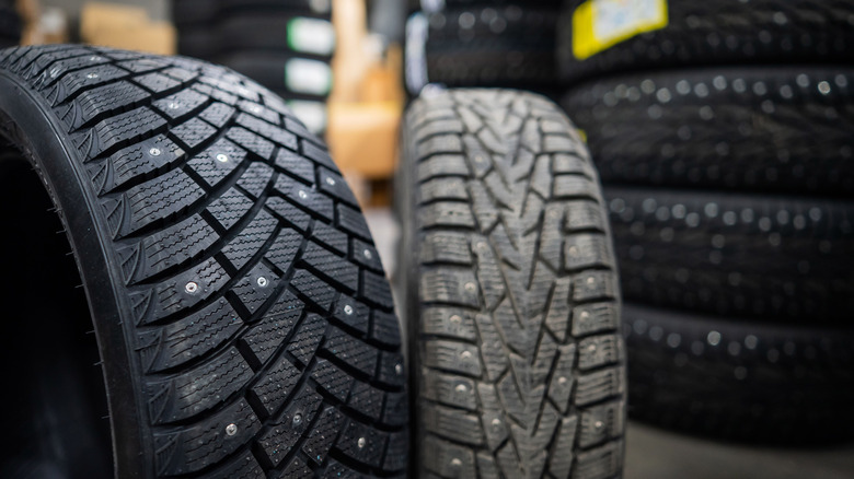 New and old studded winter tires in a tire shop