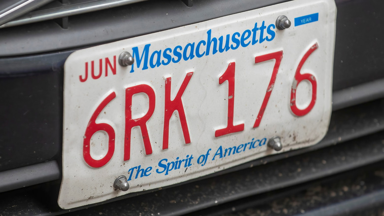 This close-up image captures a Massachusetts license plate with the slogan "The Spirit of America" in blue lettering.